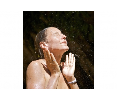 Jo Deurbrouck showers under natural desert canyon spring