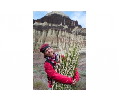 Jo Deurbrouck hugs Great Basin Wild Rye in canyon country