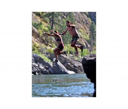 Jo Deurbrouck and her husband jumping from rocks on Salmon River